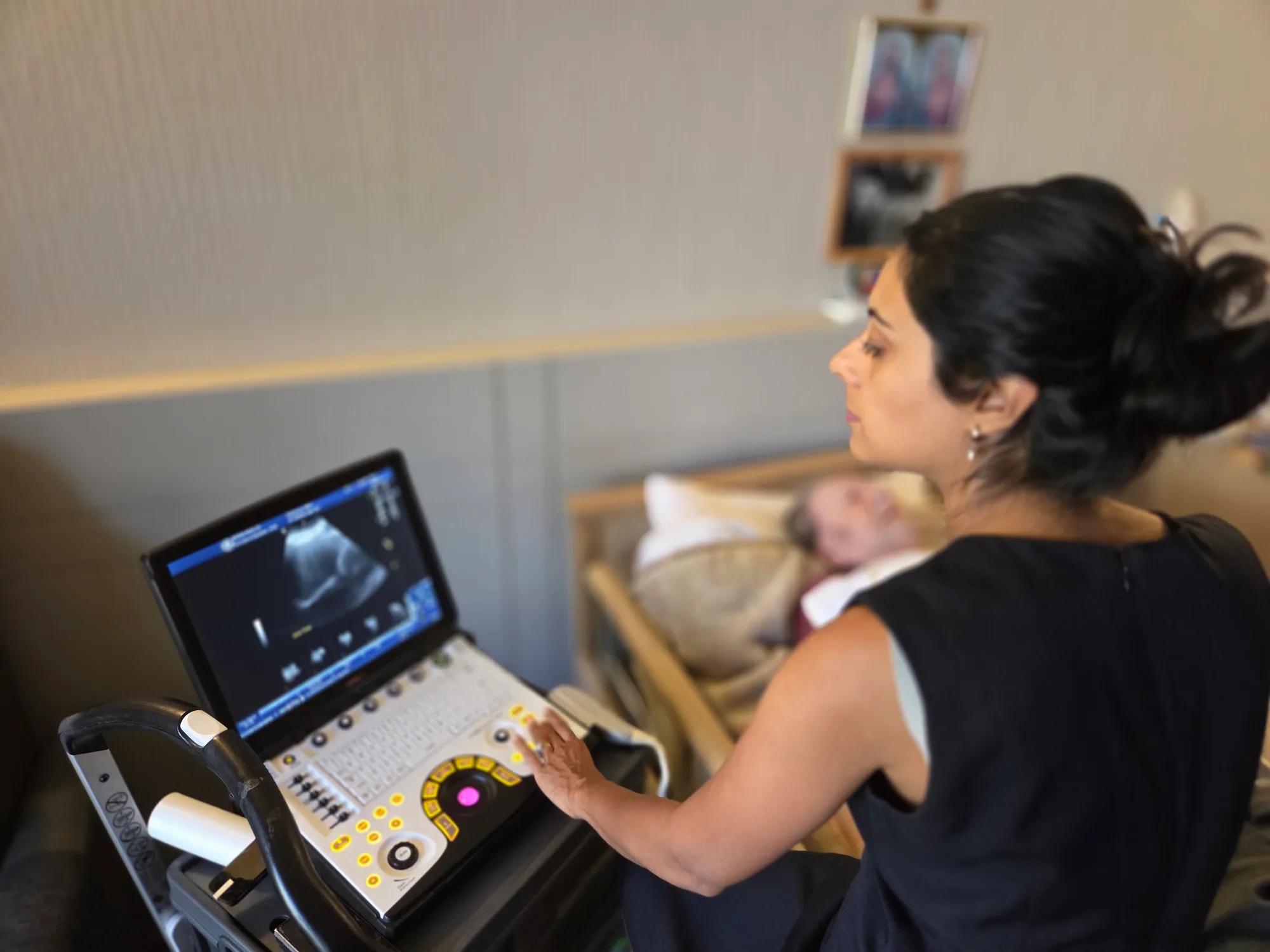 Modia Health sonographer performing a bedside ultrasound on an elderly patient