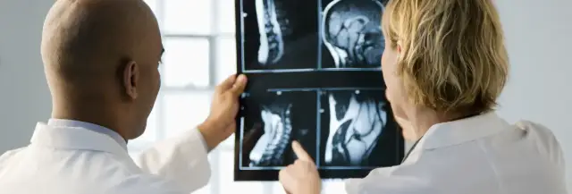 Doctor discussing X-ray results with a colleague