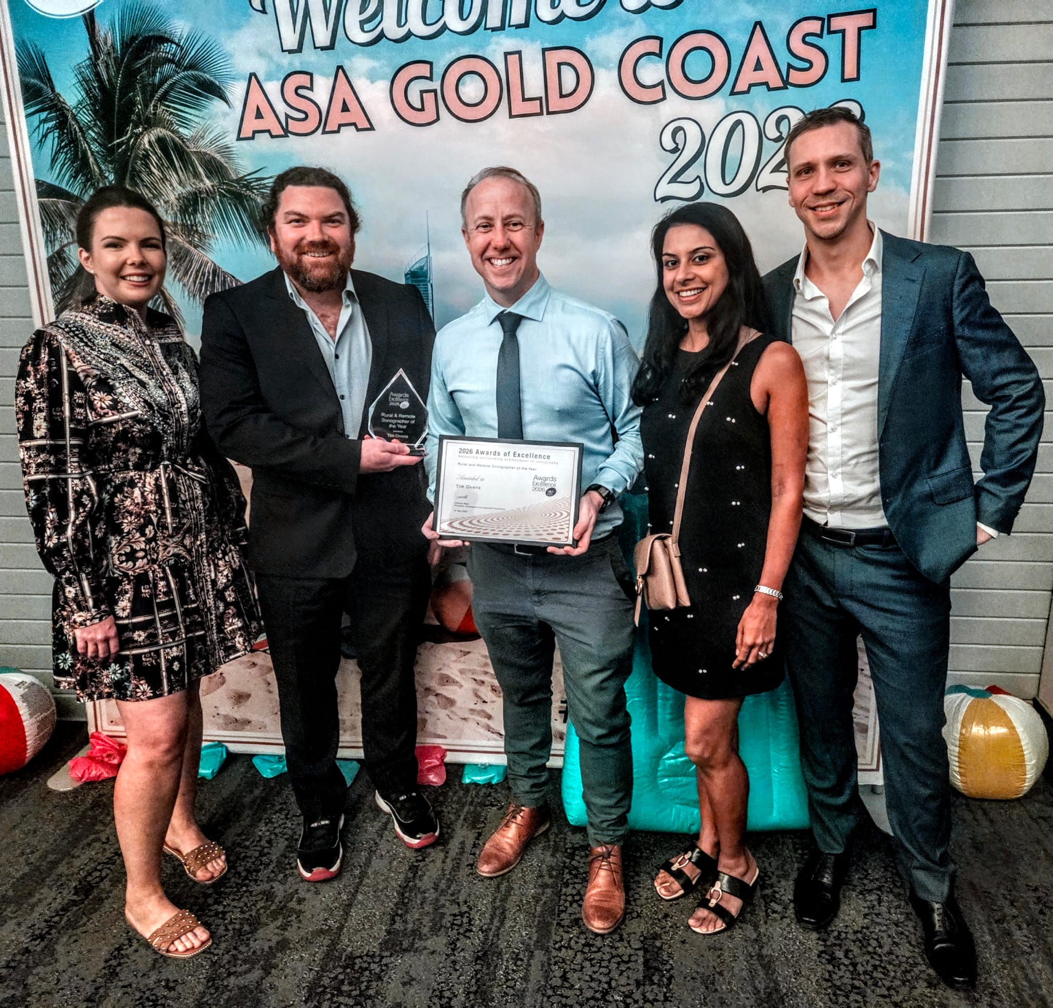 Tim Ovens with Modia Health's sonography team, holding his ASA Rural and Remote Sonographer of the Year award